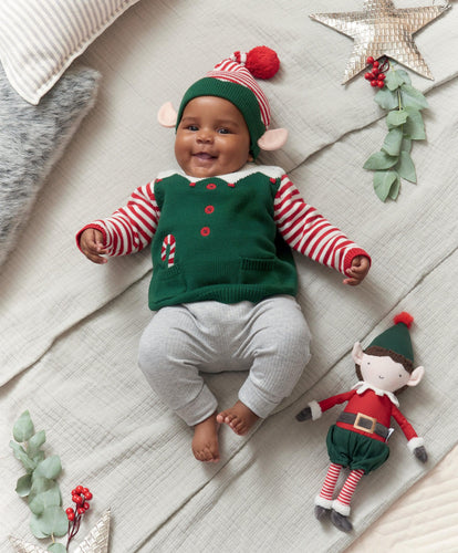 Baby’s red and green colored holiday outfi